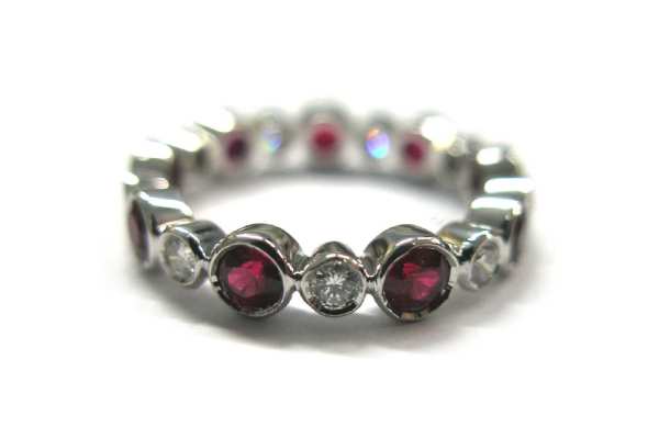 Brilliant cut round diamond and ruby bezel set ring