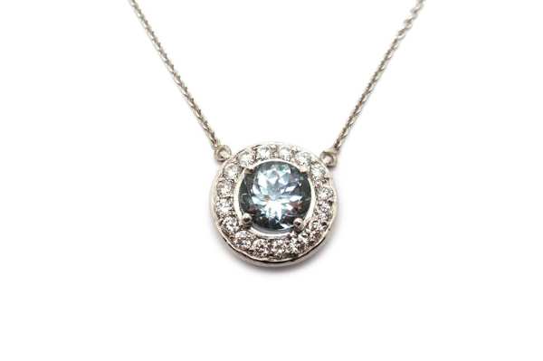 Aquamarine claw set with a diamond halo pendant 
