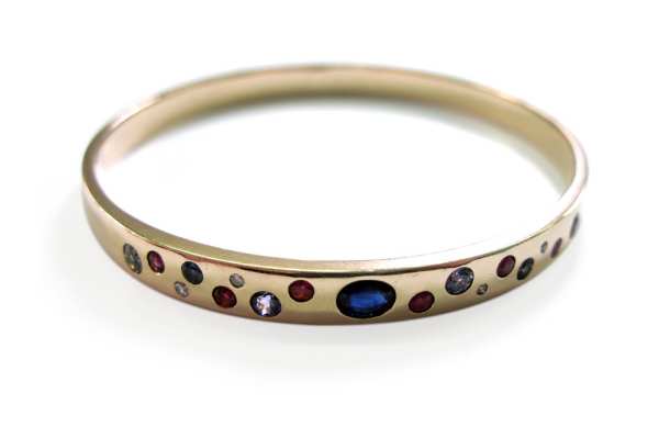 Melted down old gold bangle with customers sapphire and other gemstones hammer set