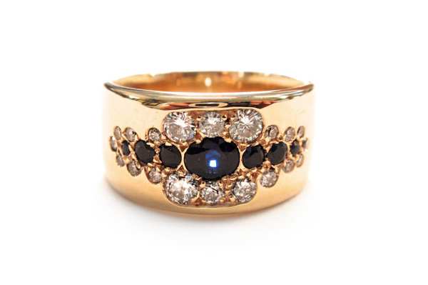 Blue sapphires and diamond pave set dress ring in wide tapering band