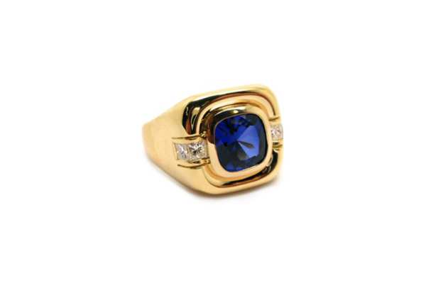 Cushion cut sapphire mens ring with channel set princes cut diamonds on the shoulders