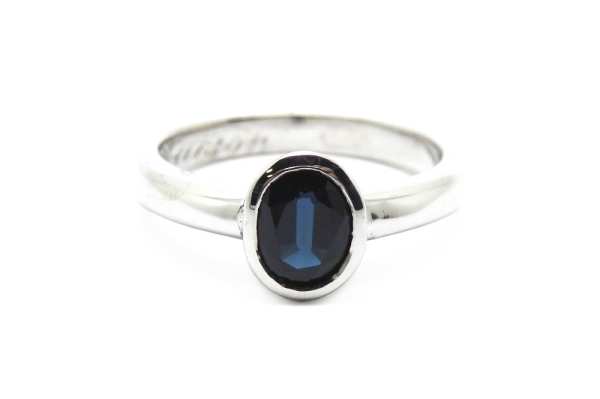 Bezel set deep blue oval sapphire ring