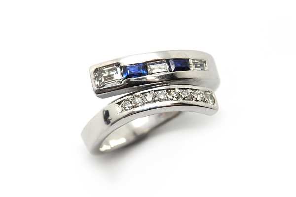 Blue sapphire and diamond cross over ring