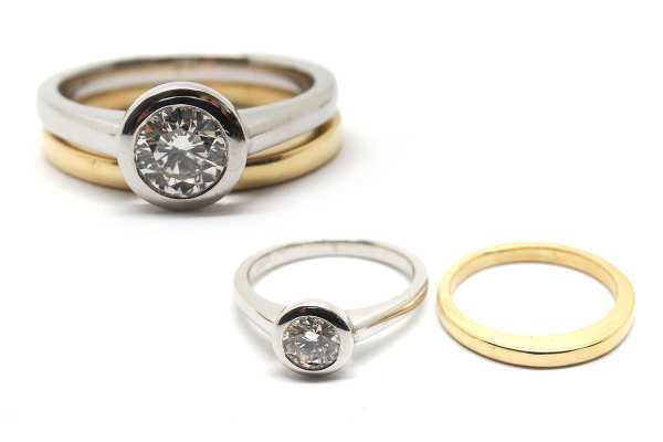 White gold bezel set solitaire with a yellow gold wedding band