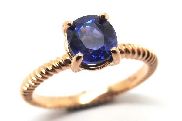 Fine twisted band and claw set sapphire ring