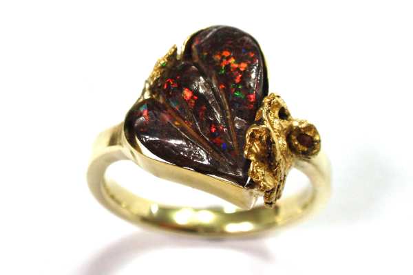 Boulder opal stylised wing with gold nugget in corner dress ring