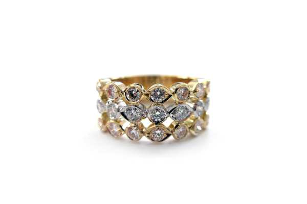 Round brilliant cut diamonds bead set into three yellow and white gold marquise shaped rows