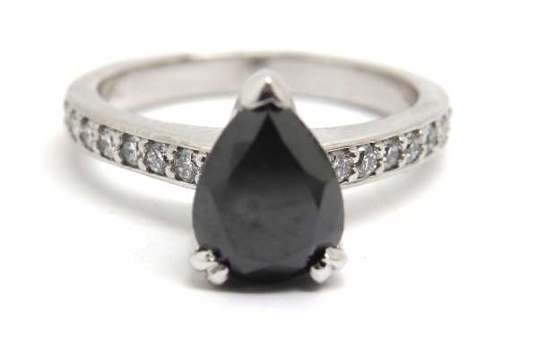 Pear shaped black diamond claw set with shoulder diamonds