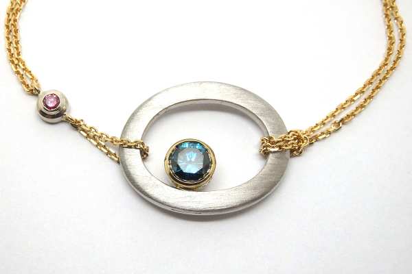 Handmade platinum and yellow gold bracelet with a blue and pink diamond