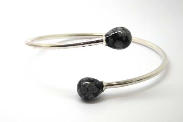 Cross over open bangle with snowflake obsidian bead ends