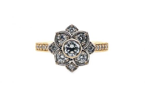Flower design white gold diamond set top with a yellow gold band with bead set stones