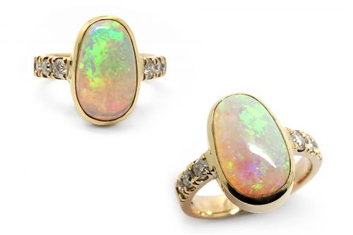 Solid opal bezel set with claw set diamond band set in yellow gold