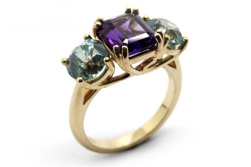 Amethyst and zircon colourful dress ring set in claws with a sweeping underrail