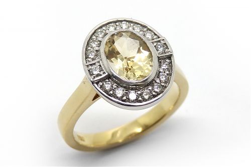 Oval citrine bezel set with a diamond bead set  halo in white gold with a yellow gold band