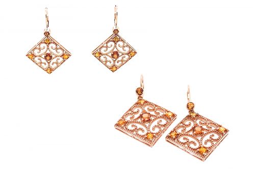 Rose gold scroll earrings with bezel and claw set orange garnets