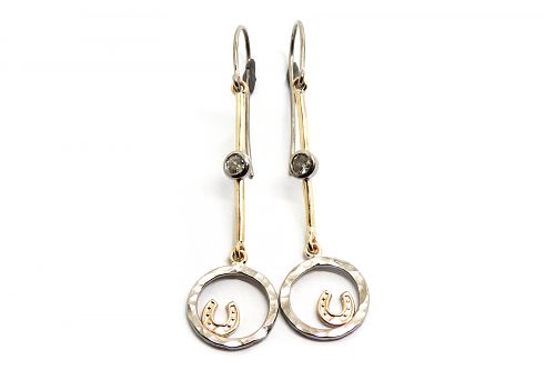 Custom made drop earrings with old cut diamonds on a white gold bar and hammered open circles and yellow gold  horse shoes inside