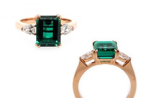 Lab grown emerald cut emerald and diamond side stones set in rose gold