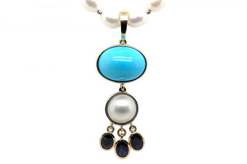 Bezel set sleeping beauty turquoise, mabe pearl and sapphires in yellow gold and fine silver with an opening bail