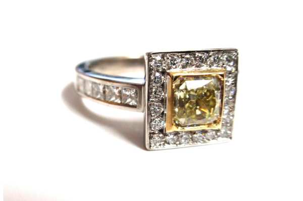 Asscher cut yellow diamond frame set with round white diamonds and a diamond band 